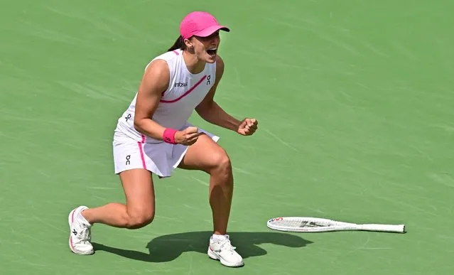 Poland's Iga Swiatek reacts after winning match point against Greece's Maria Sakkari during the ATP-WTA Indian Wells Masters women's final tennis match at the Indian Wells Tennis Garden in Indian Wells, California, on March 17, 2024. World number one Iga Swiatek powered past Greece's Maria Sakkari 6-4, 6-0 on March 17, 2024 to claim her second Indian Wells WTA title two years after she beat Sakkari for her first. (Photo by Frederic J. Brown/AFP Photo)