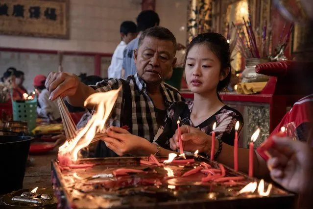 People burn incense at a Chinese temple in the Chinatown area of Yangon on February 10, 2024, on the first day of the Lunar New Year of the Dragon. (Photo by Sai Aung Main/AFP Photo)