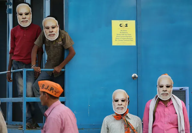 In this May 9, 2019, photo, India's ruling Bharatiya Janata Party (BJP) supporters wear masks of Indian prime minister Narendra Modi and wait for his arrival during an election campaign rally in Prayagraj, India. India's multi-phase elections, which started April 11 and last five weeks, are seen as a referendum on Prime Minister Narendra Modi and his Hindu nationalist BJP. (Photo by Rajesh Kumar Singh/AP Photo)