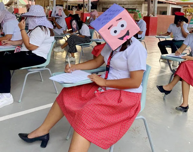 A university in the Philippines in March 2024 has come up with a novel way to stop students cheating in exams – by getting them to wear hats in the shape of animated characters and random objects such as a crate of beer. (Photo by Angelo Ebora/beampix/Solent news)