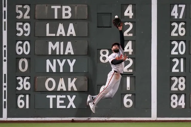 Baltimore Orioles outfielder Colton Cowser makes the catch on a fly out by Boston Red Sox's Romy Gonzalez during the eighth inning of a baseball game, Wednesday, April 10, 2024, in Boston. (Photo by Charles Krupa/AP Photo)