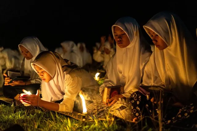 Students light candles as they prepare to read the holy Quran during the ritual Nuzulul Quran and start searching for Laylat al-Qadr (Night of Destiny), which marks the beginning of Prophet Muhammad's prophethood and the start of the revelation of the Holy Quran at the Nurul Hidayah Al-Mubarokah boarding school on March 31, 2024, in Boyolali, Central Java Province, Indonesia. Ramadan stands as a significant period within Islam, with its entirety holding special significance. Yet, it's the final 10 nights that truly shine, for among them lies the Night of Power, known as Laylat-al-Qadr in Arabic. Throughout these nights, millions of Muslims worldwide observe fasting from dawn till dusk for an entire month. Ramadan, the ninth month of the Islamic calendar, emerges as a time dedicated to spiritual reflection, prayer, and contemplation. It serves as an opportunity for individuals to exercise self-discipline, exercise self-control, and engage in self-improvement endeavors. (Photo by Garry Lotulung/Anadolu via Getty Images)