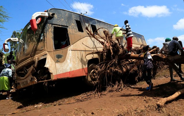 A view shows a damaged passenger bus stuck on a fallen tree after heavy flash floods wiped out several homes when a dam burst, following heavy rains in Kamuchiri village of Mai Mahiu, Nakuru County, Kenya  on April 29, 2024. (Photo by Thomas Mukoya/Reuters)