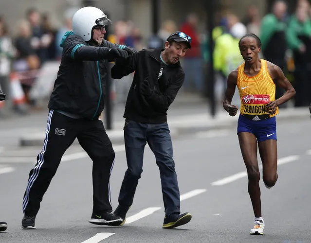 Athletics, 2016 Virgin Money London Marathon, London on April 24, 2016: Kenya's Jemima Sumgong in action as security tackle a spectator during the women's race. (Photo by Peter Cziborra/Reuters/Action Images/Livepic)