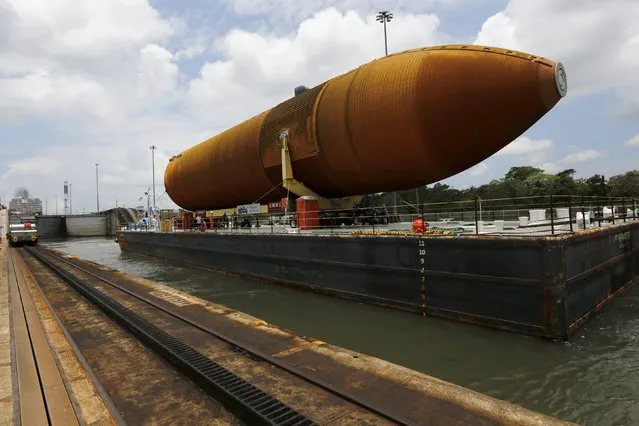A barge transporting NASA's last space shuttle external tank makes its way through the Gatun locks of the Panama Canal on the outskirts of Colon City, Panama April 25, 2016. The external tank is crossing the Panama Canal on its way to a display venue in California, according to local media. (Photo by Carlos Jasso/Reuters)