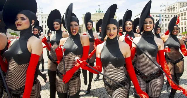 Dancers of the Friedrichstadt-Palast from the show “THE WYLD” pose during a promotional photocall in front of the Brandenburg Gate in Berlin, Germany, June 25, 2015. The 10.6 million euro ($13.5 million) show is the largest production budget in the 95-year history of Friedrichstadt-Palast. (Photo by Hannibal Hanschke/Reuters)