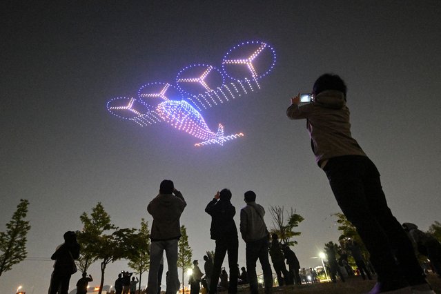 A swarm of 1,000 drones forms patterns in the night sky during a drone light show as part of the 2024 Korea Drone Expo in Incheon on May 9, 2024. (Photo by Jung Yeon-je/AFP Photo)