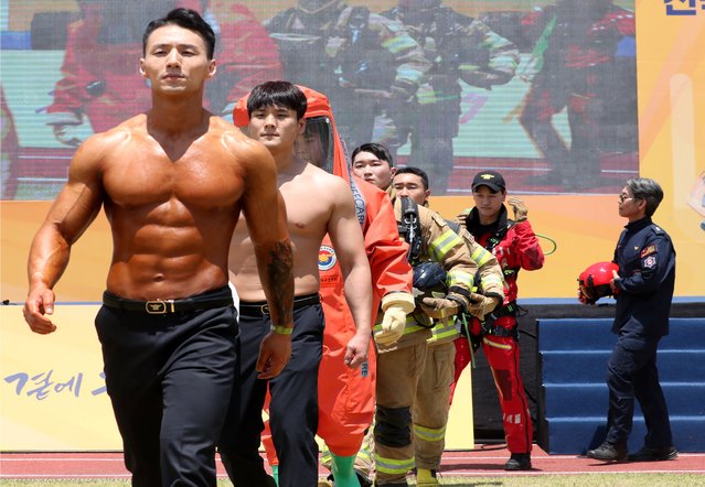 Firefighters take part in the bodybuilding event during a firefighting skills contest at the National Fire Service Academy in Gongju, South Korea on June 3, 2024. (Photo by Shin Hyeon-jong)