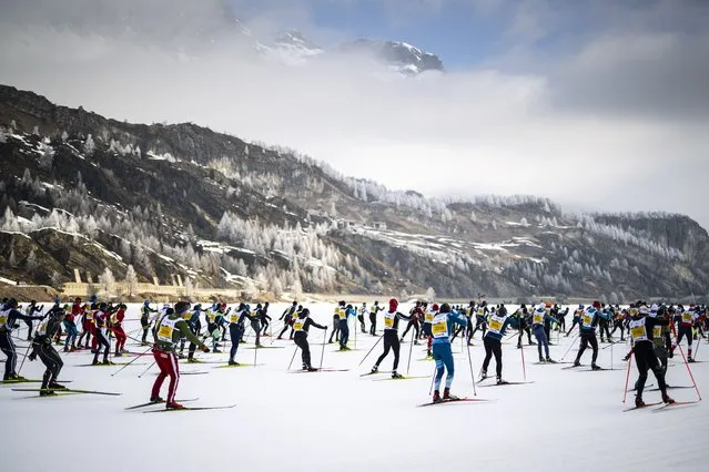 Skiers en route from Maloja to S-Chanf as they participate in the 52nd annual Engadin skiing marathon, 13 March 2022, in Maloja, Switzerland. The 42km Engadin Skimarathon is the largest cross-country skiing event in Switzerland and the second largest in the world. (Photo by Gian Ehrenzeller/EPA/EFE)