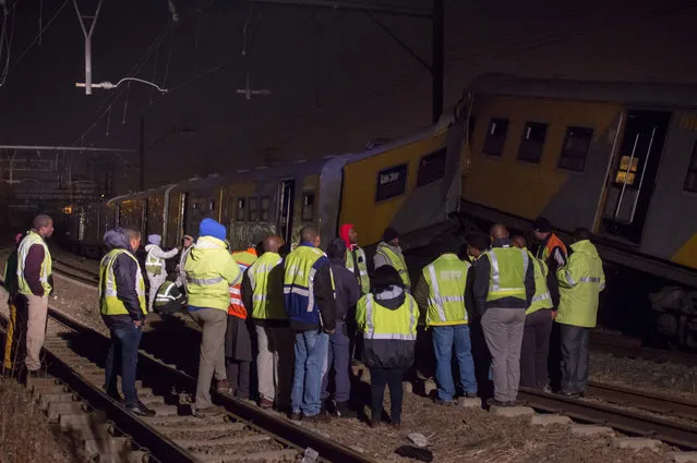 Emergency workers gather at the scene of a train collision at the Booysens train station near Johannesburg Friday July 17, 2015. A commuter train crashed into another passenger train during rush hour Friday in South Africa's largest city injuring more than 300 people, an emergency services spokeswoman said. (Photo by Jacques Nelles/AP Photo)