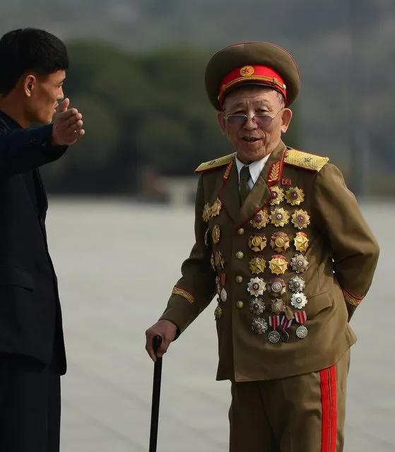 A man speaks to a highly-decorated Korean War veteran at the Mansudae Hill Grand Monument. Uniforms are big in Kim’s country. (Photo by Gavin John/Mediadrumworld.com)