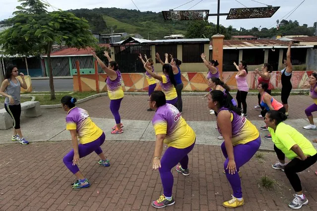 Andrea Abarca, (L) leads an aerobics class in Los Guidos de Desamparados, Costa Rica July 23, 2015. More than 300 women participated in a physical health program organized by  Abarca, which aims to combat obesity and sedentary behavior in poor women living in a slum. The National Nutrition Survey shows that the Costa Rican population has 62.4 percent of adult men who are obese, while among women the percentage was 77.3, according to local media. (Photo by Juan Carlos Ulate/Reuters)