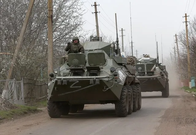 Armoured vehicles of pro-Russian troops drive along a road during Ukraine-Russia conflict near the southern port city of Mariupol, Ukraine April 17, 2022. (Photo by Alexander Ermochenko/Reuters)