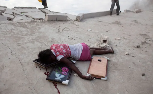 Fifteen-year-old Fabianne Geismar lies dead after being shot in the head after looting wall hangings from a destroyed store in Port-au-Prince, Haiti, January 19, 2010. (Photo by Carlos Garcia Rawlins/Reuters)