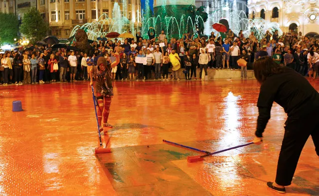 Protesters disperse color paint during a protest against the government, at central square in Skopje, Macedonia June 6, 2016. (Photo by Ognen Teofilovski/Reuters)