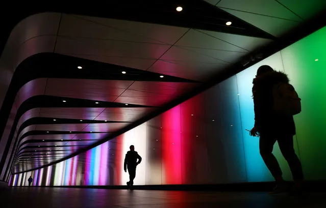 People walk through a subway tunnel between St Pancras International and King's Cross Station in London, Britain, December 27, 2019. (Photo by Hannah McKay/Reuters)
