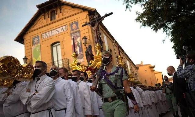 Penitents of “Mena” brotherhood carrying the statue of Christ during the procession in Malaga, Spain on October 30, 2021. Sixteen brotherhoods participate in an extraordinary procession known as “La Magna: camino de la gloria” (The great: the way of the glory) along the main streets of the city, as part of activities to commemorate the centenary of brotherhood groups. (Photo by Jesus Merida/SOPA Images/Rex Features/Shutterstock)