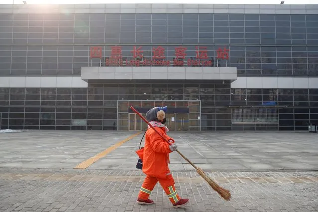 A cleaner walks past the Sihui Long Distance Bus Station in Beijing after the city has stoped inter-province buses services as the country is hit by an outbreak of the new coronavirus, January 26, 2020. (Photo by Thomas Peter/Reuters)