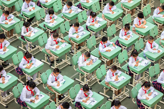 Students write with hard pens during a calligraphy competition at a primary school on June 13, 2022 in Hohhot, Inner Mongolia Autonomous Region of China. (Photo by Ding Genhou/VCG via Getty Images)