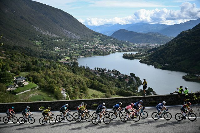 The pack of riders (peloton) cycles in the ascent of Forcellino Di Bianzano, near Lago di Endine lake, during the 118th edition of the Giro di Lombardia (Tour of Lombardy), a 252km cycling race from Bergamo to Como on October 12, 2024. (Photo by Marco Bertorello/AFP Photo)