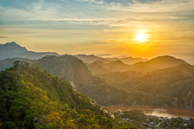 Sunset over lush green jungle covered hills with the Beni River visible in Rurrenabaque, Bolivia on May 25, 2022. (Photo by Getty Images/iStockphoto)