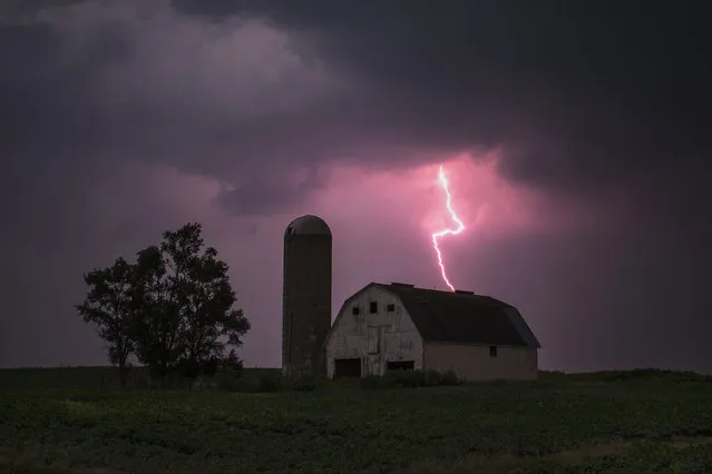 Lighting strikes over a barn surrounded by a soybean crop in Donnellson, Iowa, July 13, 2012. (Photo by Adrees Latif/Reuters)