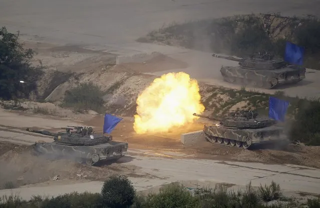 South Korean army K1A1 tanks fire live rounds during a U.S.-South Korea joint live-fire military exercise at a training field near the demilitarized zone separating the two Koreas in Pocheon, South Korea, August 28, 2015. North Korean leader Kim Jong Un called this week's accord between the rival Koreas “a landmark occasion” paving the way for defused military tension and improved ties, but said it was the strength of its armed forces that made the deal possible. (Photo by Kim Hong-Ji/Reuters)