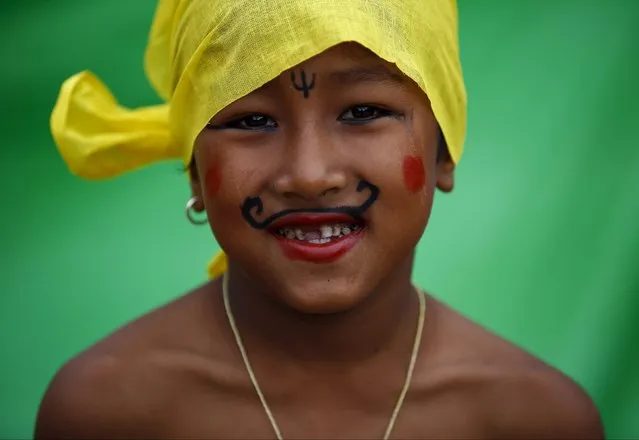 A boy, dressed up as a holy man, takes part in a parade to mark the Gaijatra festival, also known as “cow festival”, in Kathmandu, Nepal August 30, 2015. (Photo by Navesh Chitrakar/Reuters)