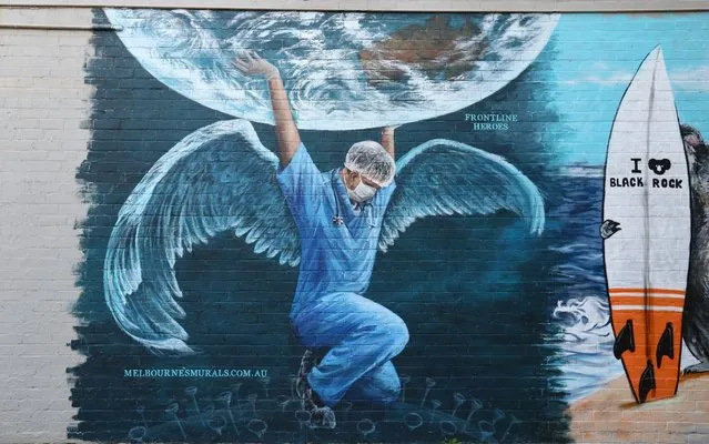 A mural to honor the medics currently helping to fight COVID-19 is seen on April 22, 2020 in Melbourne, Australia. All non-essential business are closed and strict social distancing rules are in place in response to the COVID-19 pandemic, while public gatherings are limited to two people. New South Wales and Victoria have enacted additional lockdown measures to allow police the power to fine people who breach the two-person outdoor gathering limit or leave their homes without a reasonable excuse. Queensland, Western Australia, South Australia, Tasmania and the Northern Territory have all closed their borders to non-essential travellers and international arrivals into Australia are being sent to mandatory quarantine in hotels for 14 days. (Photo by Robert Cianflone/Getty Images)