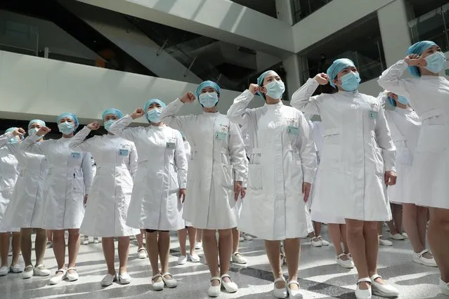 Nurses recite an oath during a ceremony marking International Nurses Day, at Tongji Hospital in Wuhan, in China's central Hubei province on May 12, 2020. As frontline hospital staff are constantly facing the risks from the COVID-19 coronavirus outbreak, the world is marking International Nurses Day, celebrated around the world every May 12, the anniversary of Florence Nightingale's birth. (Photo by Reuters/China Daily)