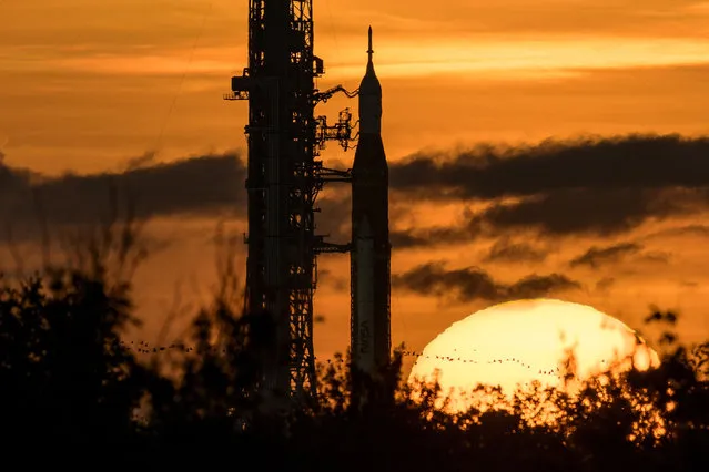 In this handout image provided by NASA, NASA's Space Launch System (SLS) rocket with the Orion spacecraft aboard is seen during sunrise atop a mobile launcher at Launch Pad 39B as preparations for launch continue, at NASAs Kennedy Space Center, August 31, 2022 in Florida. NASAs Artemis I flight test is the first integrated test of the agencies deep space exploration systems: the Orion spacecraft, SLS rocket, and supporting ground systems. (Photo by Bill Ingalls/NASA via Getty Images)