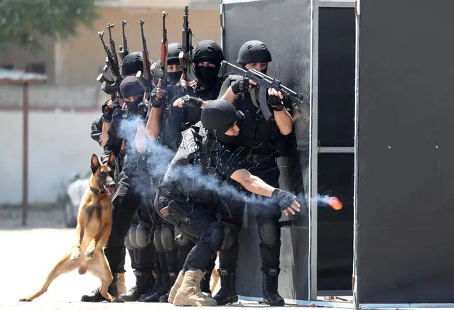 A Palestinian Hamas police cadet throws a sound grenade as he demonstrates his skills with his colleagues during a graduation ceremony, amid concerns about the spread of the coronavirus disease (COVID-19) in Gaza City on May 7, 2020. (Photo by Mohammed Salem/Reuters)