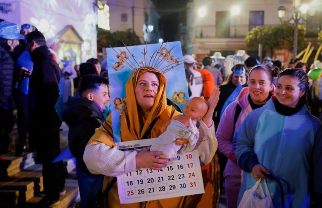 Miriam Jimenez, 32, dressed up as the Virgin Mary of a calendar, poses for a photo as she celebrates the New Year in Coin, near Malaga, southern Spain on December 31, 2023. (Photo by Jon Nazca/Reuters)