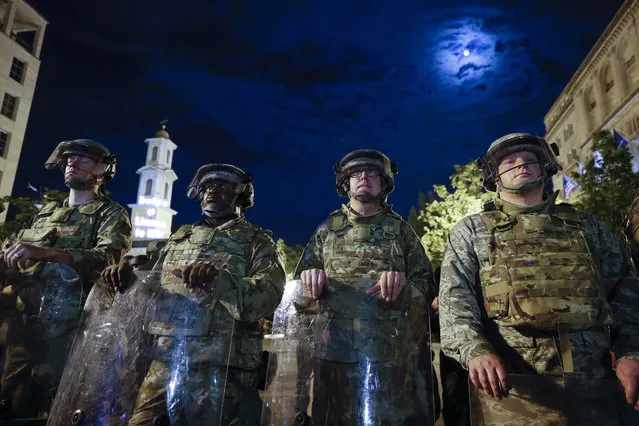 Utah National Guard soldiers stand on a police line as demonstrators gather to protest the death of George Floyd, Thursday, June 4, 2020, near the White House in Washington. Floyd died after being restrained by Minneapolis police officers. (Photo by Alex Brandon/AP Photo)