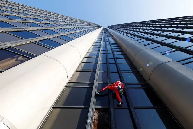 French "Spiderman" Alain Robert climbs Montparnasse Tower to highlight the fuel and energy crisis, amid weeks-long union-led blockades of petrol depots in the country, in Paris, France on October 12, 2022. (Photo by Gonzalo Fuentes/Reuters)