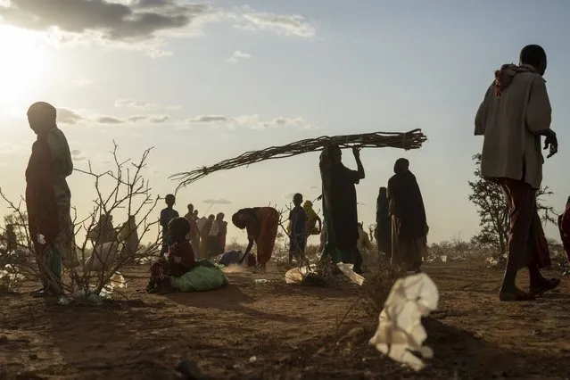 Somalis who have been displaced settle at a camp on the outskirts of Dollow, Somalia Tuesday, September 19, 2022. Somalia has long known droughts, but the climate shocks are now coming more frequently, leaving less room to recover and prepare for the next. (Photo by Jerome Delay/AP Photo)