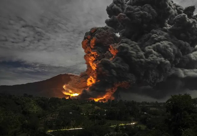 Mount Sinabung volcano erupts, as seen from Tiga Pancur village, Karo Regency in Indonesia's North Sumatra province October 8, 2014. (Photo by Y. T. Haryono/Reuters)