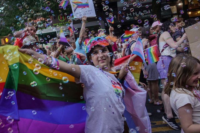 People celebrate Brooklyn Pride Day as they cheer and dance during a parade while others watch from the sidewalk in Brooklyn, New York on June 9, 2024. (Photo by Maye-E Wong/Reuters)