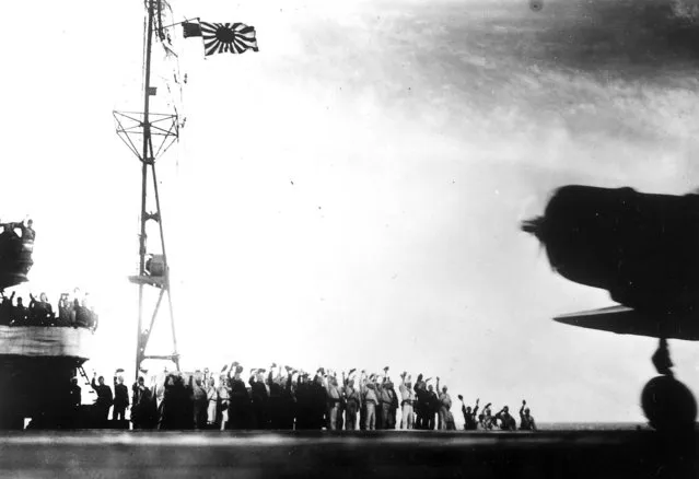 This photograph, from a Japanese film later captured by American forces, is taken aboard the Japanese aircraft carrier Zuikaku, just as a Nakajima “Kate” B-5N bomber is launching off deck for the second wave of the attack on Pearl Harbor on December 7, 1941. (Photo by Associated Press)
