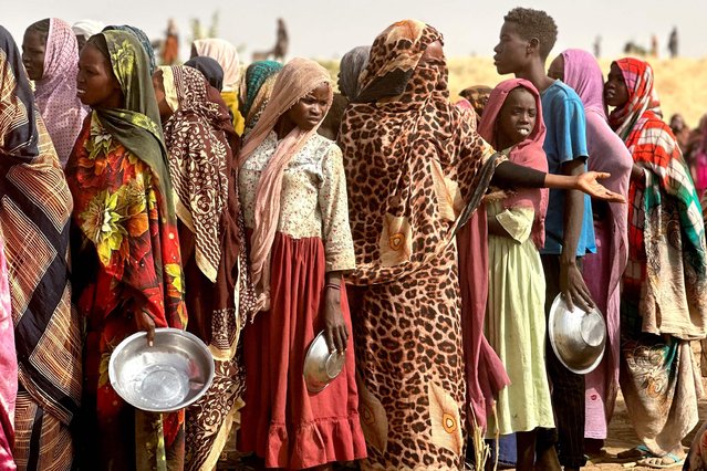 People who fled the Zamzam camp for the internally displaced after it fell under RSF control, queue for food rations in a makeshift encampment in an open field near the town of Tawila in war-torn Sudan's western Darfur region on April 13, 2025. Sudan's paramilitary Rapid Support Forces (RSF) announced on April 13 that it had taken control of the famine-hit Zamzam camp, home to over 500,000 refugees according to the United Nations, after two days of heavy shelling and gunfire, amid its ongoing war with the country's army and affiliated forces. (Photo by AFP Photo/Stringer)