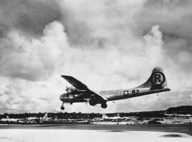 In this August 6, 1945, file photo, the “Enola Gay” Boeing B-29 Superfortress lands at Tinian, Northern Mariana Islands, after the U.S. atomic bombing mission against the Japanese city of Hiroshima. Enola Gay dropped the 4-ton “Little Boy” uranium bomb from a height of 9,600 meters (31,500 feet) on the city center, targeting the Aioi Bridge. (Photo by Max Desfor/AP Photo/File)