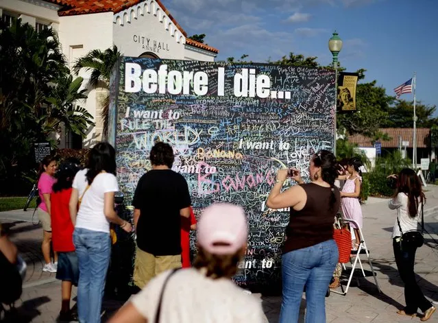 Hundreds of sentiments were scribbled on a “Before I die...” chalkboard at the festival on Saturday. (Photo by Thomas Cordy/The Palm Beach Post)