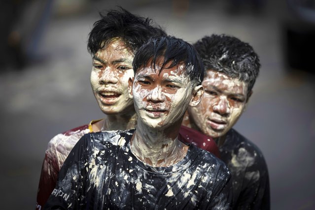 Young men don a powdery paste called din sor pong believed to bring blessings and protection as they take part in the Songkran water festival marking the Thai New Year in the Prachinburi province of central Thailand, April 13, 2025. (Photo by Wason Wanichakorn/AP Photo)