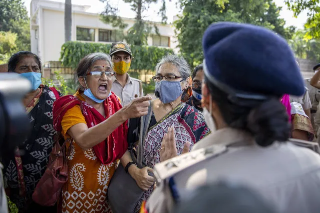 An Indian activist argues with a police officer before being detained by police during a protest in New Delhi, India, Wednesday, September 30, 2020. The gang rape and killing of the woman from the lowest rung of India's caste system has sparked outrage across the country with several politicians and activists demanding justice and protesters rallying on the streets. (Photo by Altaf Qadri/AP Photo)