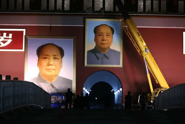 Workers update a portrait of Mao Zedong to celebrate the forthcoming national holiday in Beijing, China on September 28, 2016. (Photo by Imaginechina/Rex Features/Shutterstock)
