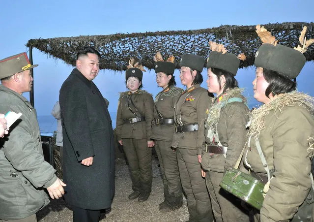 Kim Jong Un talks with soldiers of the Korean People's Army (KPA) taking part in the landing and anti-landing drills of KPA Large Combined Units 324 and 287 and KPA Navy Combined Unit 597, on March 25, 2013. (Photo by Reuters/KCNA)