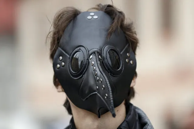 A man wears a mask as demonstrators gather to protest the COVID-19 preventative measures downtown Prague, Czech Republic, Wednesday, October 28, 2020. (Photo by Petr David Josek/AP Photo)