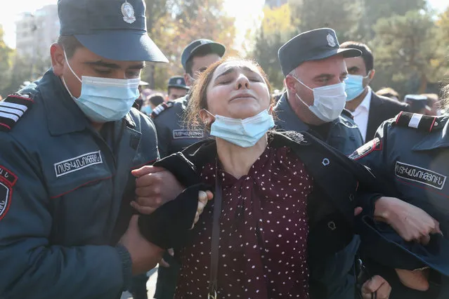 Police officers detain a woman participating in a protest against the agreement signed to end the war in Nagorno-Karabakh in Yerevan, Armenia on November 11, 2020. On 9 November, Armenia's Prime Minister Pashinyan, Russia's President Putin and Azerbaijan's President Aliyev signed a joint statement on a complete ceasefire in disputed Caucasus Mountains territory of Nagorno-Karabakh. (Photo by Stanislav Krasilnikov/TASS)
