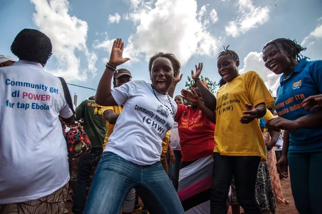 Women celebrate as their country is declared Ebola free in the city of Freetown Sierra Leone, Saturday, November 7, 2015. The World Health Organization declared Sierra Leone free from Ebola transmissions on Saturday, as West Africa battles to stamp out the deadly virus that is holding on in neighboring Guinea. (Photo by Aurelie Marrier d'Unienvil/AP Photo)