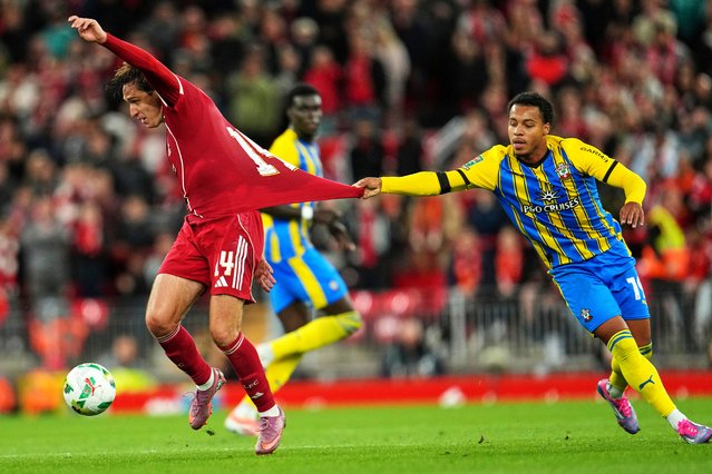 Southampton's Cameron Archer, right, holds Liverpool's Federico Chiesa during the English League Cup third round soccer match between Liverpool and Southampton at the Anfield stadium in Liverpool, England, Tuesday, September 23, 2025. (Photo by Jon Super/AP Photo)